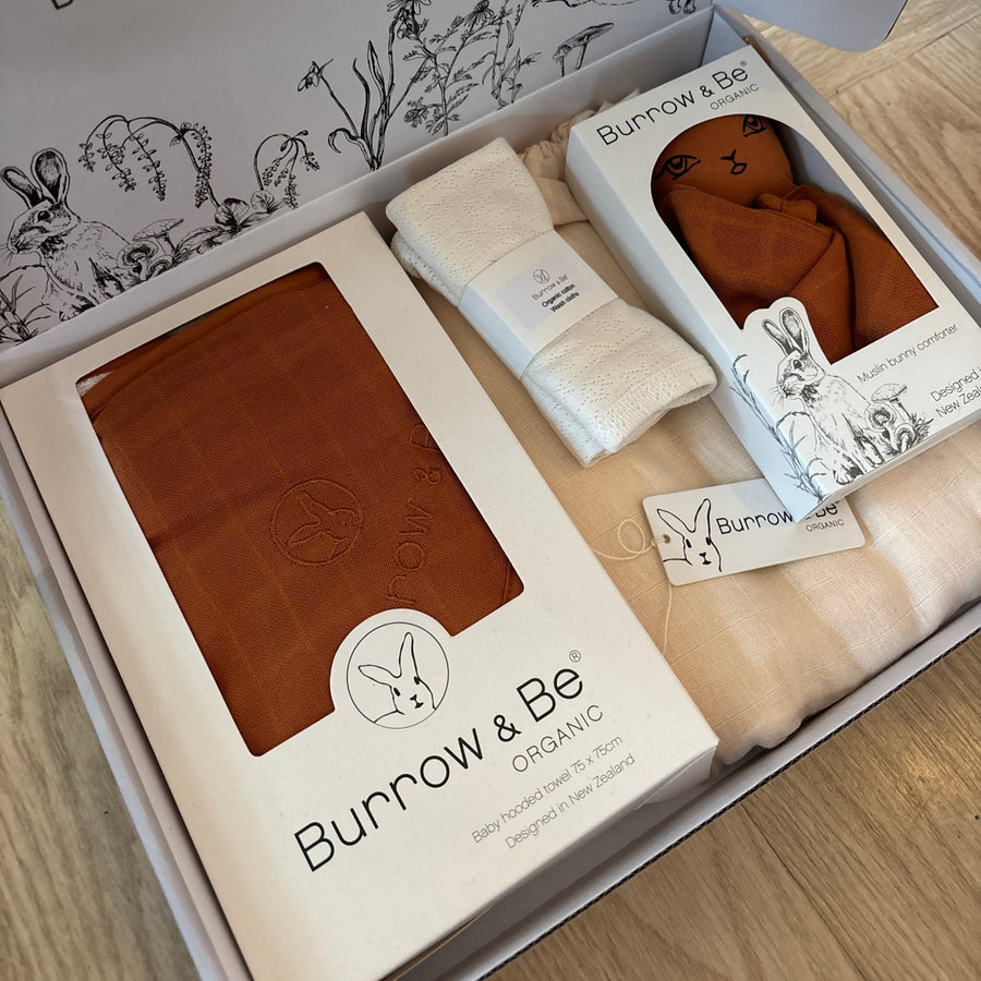 Box containing Burov & Be products on a wooden surface