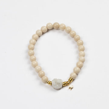 Cream beads with moonstone disc and tiny gold heart bracelet by Stella + Gemma